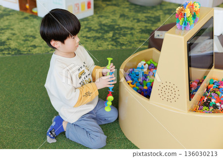 Boy playing with indoor playset Boy playing with indoor playset 136030213