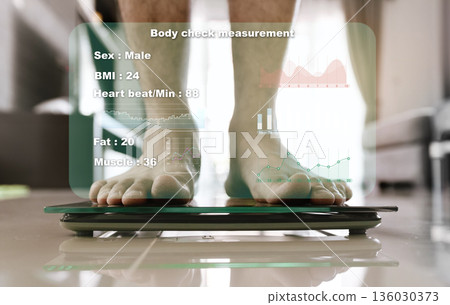 Close-up image of a person's feet while standing on a weighing scale, with a virtual screen displaying various body measurements. 136030373