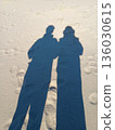 The shadows of two people reflected on the beach 136030615