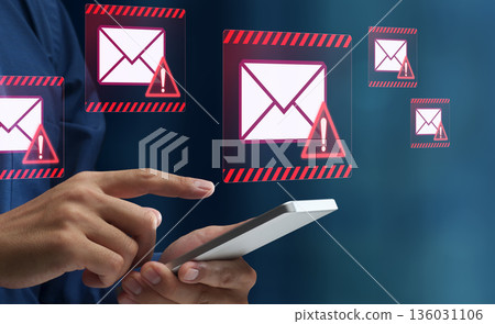 Spam email. Phishing and fraudulent email. Smartphone with warning triangle icon. Tap the smartphone screen. 136031106