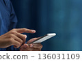 Man using smartphone. Close up of hand tapping on smartphone screen. Smart mobile device 136031109