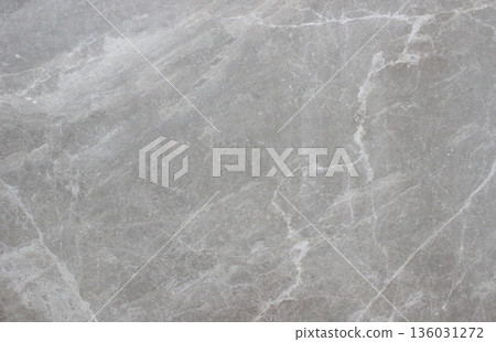 Tundra Grey marble texture with smooth surface and soft white vein patterns spreading across the natural stone surface. Tundra Grey marble texture with smooth surface and soft white vein patterns spreading across the natural stone surface. 136031272