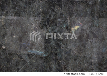 Close up of Labradorite Blue Lemurian granite stone showing blue and rainbow iridescence effects on the rock surface. Close up of Labradorite Blue Lemurian granite stone showing blue and rainbow iridescence effects on the rock surface. 136031286