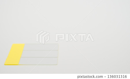 A low-angle photo of a glass slide placed in the bottom left corner against a white background A low-angle photo of a glass slide placed in the bottom left corner against a white background 136031316