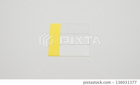 A standard-angle photograph of a glass slide placed vertically in the center of a white background 136031377