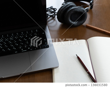 Computer, notebook and headphones on a table Computer, notebook and headphones on a table 136031580