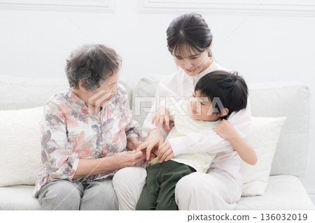 Grandchildren, great-grandchildren, and grandmother - three people from four generations 136032019