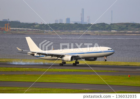 Airplane landing on the airport runway Airplane landing on the airport runway 136032035