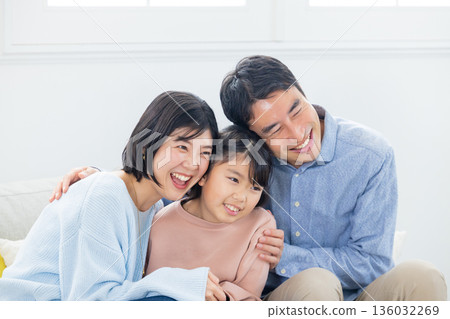 Family sitting on the sofa 136032269