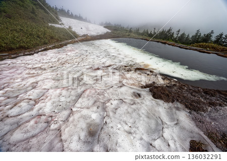 Mt. Aizu-Komagatake and Komanooike Pond, shrouded in mist and remaining snow 136032291