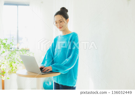 A woman watching a smartphone A woman watching a smartphone 136032449