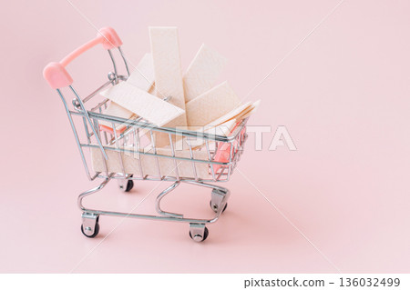 Mini shopping cart with sugarfree chewing gum sticks on pastel pink background 136032499