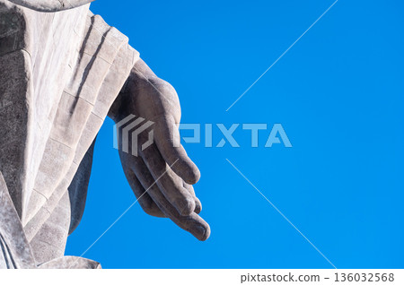 Looking up at the blue sky and the hands of a Buddha statue: A minimalist graphic background that makes use of white space Looking up at the blue sky and the hands of a Buddha statue: A minimalist graphic background that makes use of white space 136032568