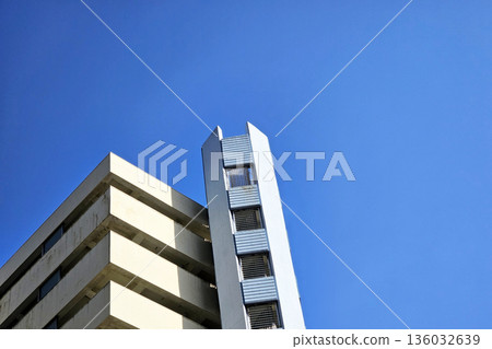 Minimal modern commercial building against a clear blue sky. Minimal modern commercial building against a clear blue sky. 136032639