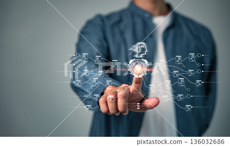 AI is visualized with a human hand touching a glowing digital interface, connecting robot technology and data, which symbolizes future development and innovation using ai in tech 136032686
