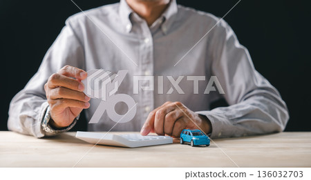 Person calculating car loan interest rates, auto finance management, holding percent symbol representing increase, using calculator to determine vehicle sale price, tax for responsible planning 136032703