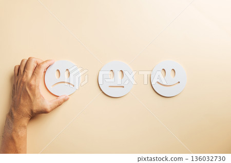 Negative customer feedback choice, male hand selecting unhappy face emoji, indicating poor service review, bad business experience, low satisfaction, user survey rating selection Negative customer feedback choice, male hand selecting unhappy face emoji, indicating poor service review, bad business experience, low satisfaction, user survey rating selection 136032730