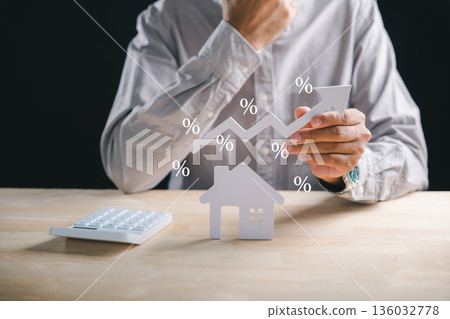 Man planning home property investment, calculating rising house loan interest rates, finance concept showing real estate market growth and new purchase strategy Man planning home property investment, calculating rising house loan interest rates, finance concept showing real estate market growth and new purchase strategy 136032778