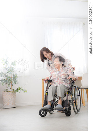 Caring for a wheelchair-bound mother at home, full-body conversation while looking into each other's eyes Caring for a wheelchair-bound mother at home, full-body conversation while looking into each other's eyes 136032804