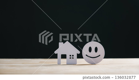 Real estate customer satisfaction home house concept shown by paper property model and happy face, representing best client reviews and feedback on construction service 136032877