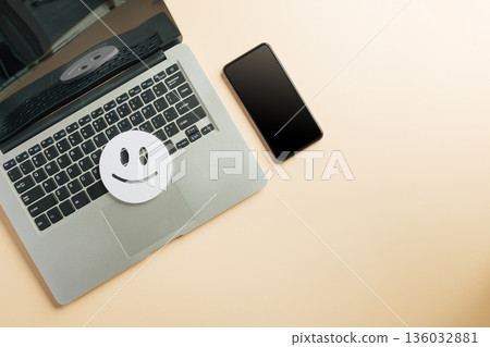 Customer feedback review survey on laptop, smartphone shows digital satisfaction assessment, online client input for social media evaluation, happy face icon represents positive service 136032881