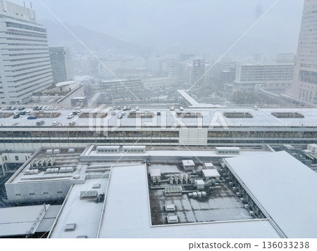 Snow falling at JR Hiroshima Station at dawn _ Snowy Hiroshima Station _ Winter _ Snow Scene 136033238