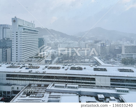 Snow falling at JR Hiroshima Station at dawn _ Snowy Hiroshima Station _ Winter _ Snow Scene 136033240