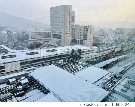 Snow falling at JR Hiroshima Station at dawn _ Snowy Hiroshima Station _ Winter _ Snow Scene 136033242