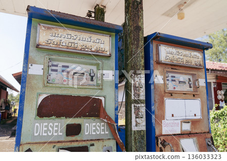 Old abandoned gas stations with inscriptions in Thai and English Diesel and Gasoline at an abandoned gas station on Koh Kho Khao Island in Thailand. High quality photo 136033323