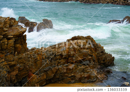 Waves of the East Sea crash against the breakwater and rocky shore, South Korea Waves of the East Sea crash against the breakwater and rocky shore, South Korea 136033339