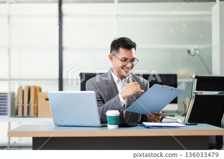 Business man using tablet and laptop for doing math finance on an office desk, tax, report, accounting, statistics, Business man using tablet and laptop for doing math finance on an office desk, tax, report, accounting, statistics, 136033479
