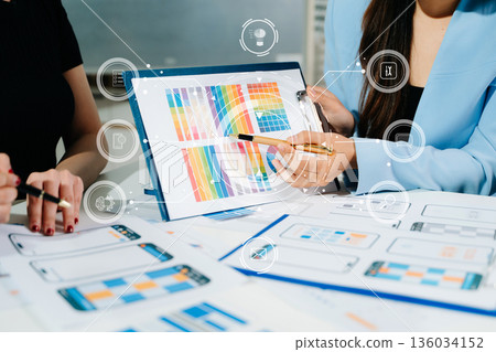 Close up view of UI developer team brainstorming on their project with laptop, smartphone and digital tablet. Creative digital development agency. 136034152