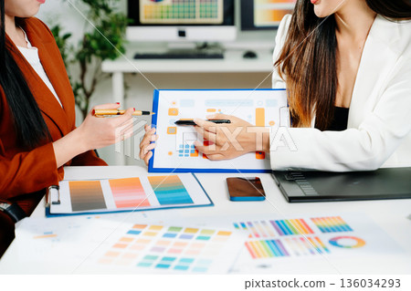 Creative female designers team using pen tablet and color palette working in graphic design Choose colors for working on tablets and computer designs. 136034293