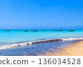 View of tropical sandy Nungwi beach and traditional wooden dhow boats in the Indian ocean on Zanzibar, Tanzania 136034528