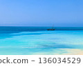 View of tropical sandy Nungwi beach and traditional wooden dhow boat in the Indian ocean on Zanzibar, Tanzania 136034529