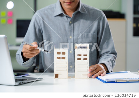 Salesman Hands On House Model , Small Toy House Small Mortgage Property insurance and concepts real estate 136034719