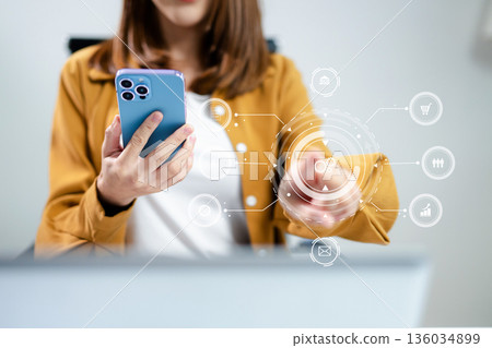 Digital marketing media in virtual screen.businesswoman hand working with mobile phone and modern compute Digital marketing media in virtual screen.businesswoman hand working with mobile phone and modern compute 136034899