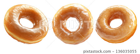 Tasty round donut topped with caramel and vanilla glaze swirl, isolated on white transparent background 136035055