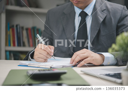 Businessman signing document and contract approval in office, paper agreement validation, authority confirmation, corporate paperwork, legal deal, professional decision making concept. 136035373