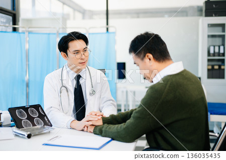 Doctor comforting worried patient in medical office, showing empathy and care. Perfect for healthcare, counseling, and mental health awareness themes. Doctor comforting worried patient in medical office, showing empathy and care. Perfect for healthcare, counseling, and mental health awareness themes. 136035435