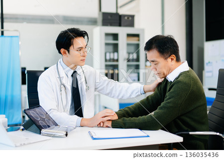 Doctor comforting worried patient in medical office, showing empathy and care. Perfect for healthcare, counseling, and mental health awareness themes. Doctor comforting worried patient in medical office, showing empathy and care. Perfect for healthcare, counseling, and mental health awareness themes. 136035436
