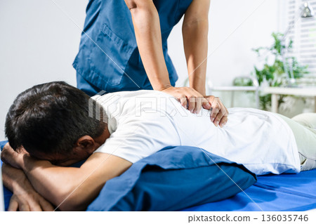 Doctor consulting with patient Back problems Physical therapy concept 136035746