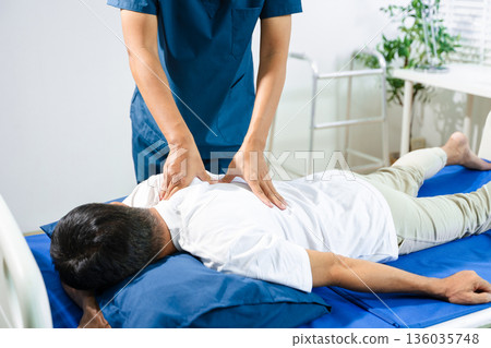 Doctor consulting with patient Back problems Physical therapy concept 136035748