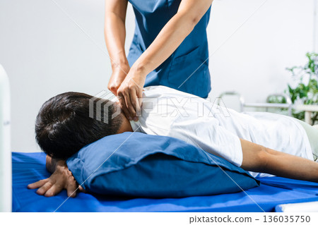 Doctor consulting with patient Back problems Physical therapy concept 136035750