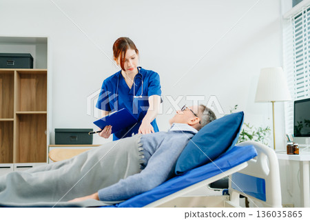 A nurse in blue scrubs conducts a bedside checkup for a senior patient in a bright room, highlighting real people, A nurse in blue scrubs conducts a bedside checkup for a senior patient in a bright room, highlighting real people, 136035865