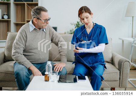 Senior man consulting nurse at home, discussing health and recovery with care, compassion, and trust. Healthcare and support service 136035914