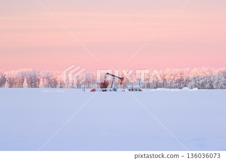 Snow Covered Oil Pumpjack at Winter Sunrise Snow Covered Oil Pumpjack at Winter Sunrise 136036073
