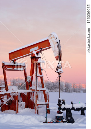 Snow Covered Oil Pumpjack at Winter Sunrise Snow Covered Oil Pumpjack at Winter Sunrise 136036085