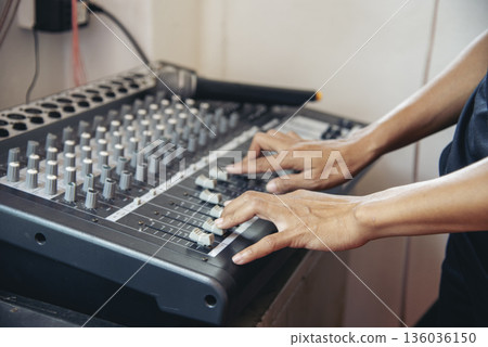 Production sound engineer woman hands adjusting volume equalizer voice, mixing console. DJ sound engineering working on recording studio mixing voice control. Producer remix tune music sound record Production sound engineer woman hands adjusting volume equalizer voice, mixing console. DJ sound engineering working on recording studio mixing voice control. Producer remix tune music sound record 136036150