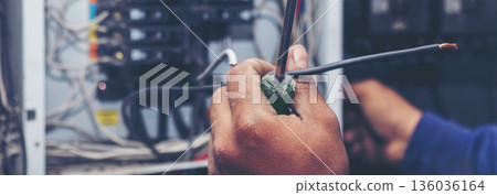 Banner Electrical mechanic technician check wire electric cabinet. Inspector men hands working maintenance service. Electrician circuit repair operation. Men hands fix breaker with copy space Banner Electrical mechanic technician check wire electric cabinet. Inspector men hands working maintenance service. Electrician circuit repair operation. Men hands fix breaker with copy space 136036164